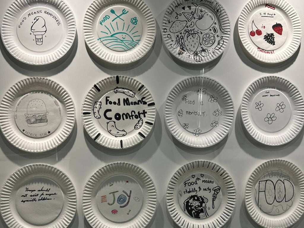 Some paper plates decorated by students responding to the question What does Food Mean to You?