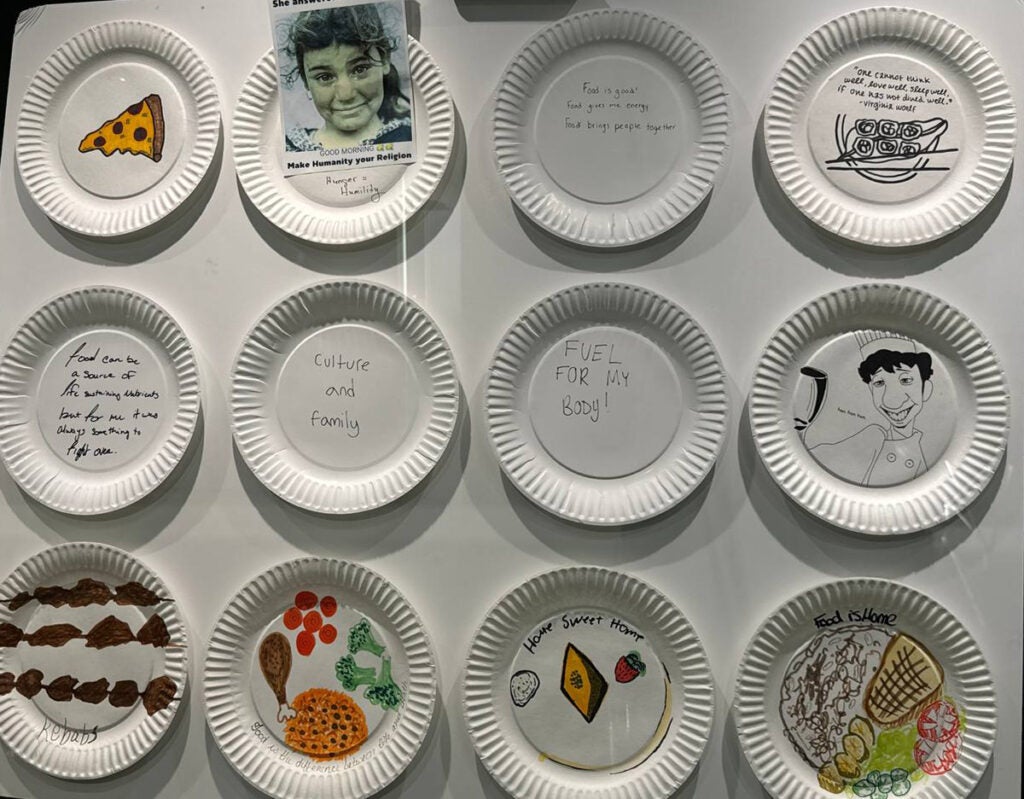 Some paper plates decorated by students responding to the question What does Food Mean to You?